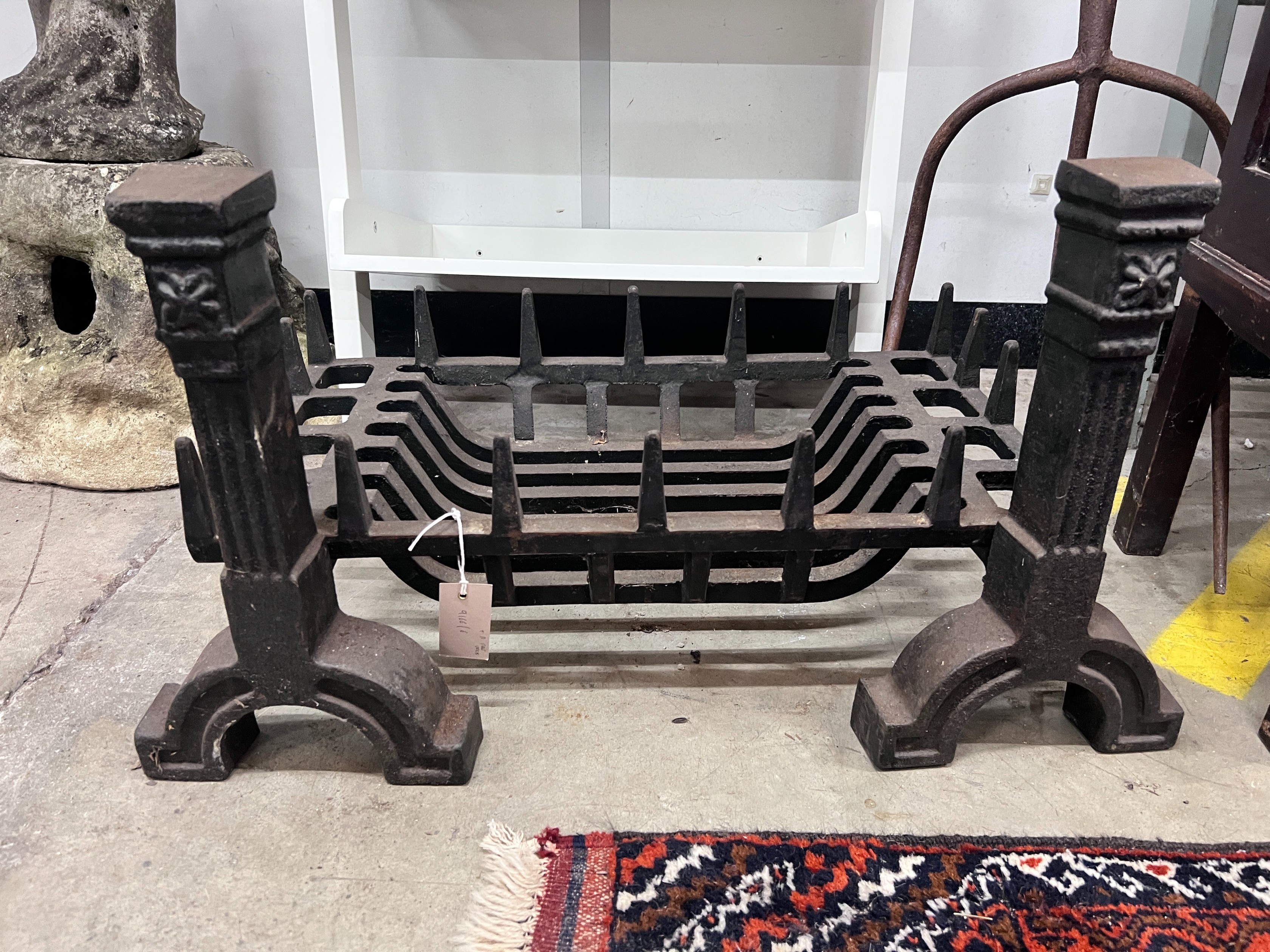 A cast iron fire grate, length 61cm, depth 33cm and a pair of fire dogs *Please note the sale commences at 9am.